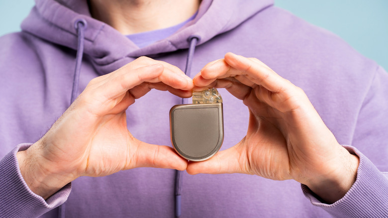 Hands holding pacemaker