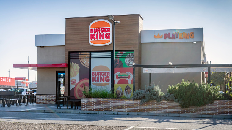The exterior of a Burger King fast food restaurant with colorful signage