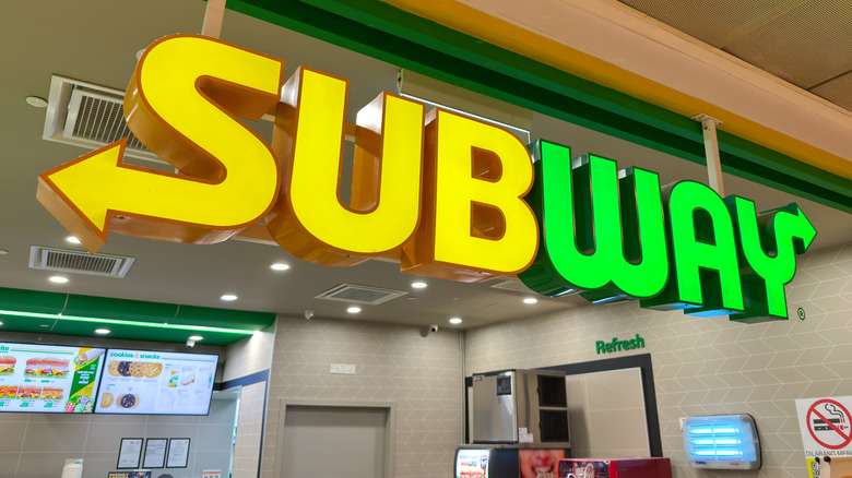 Yellow and green Subway sign inside a Subway restaurant