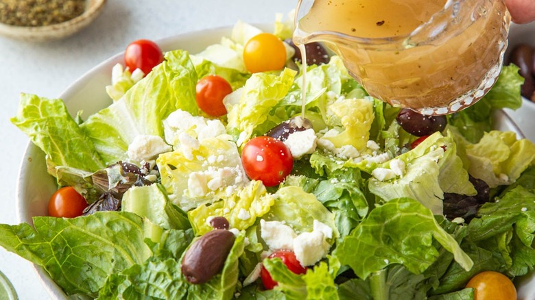 pouring dressing on salad