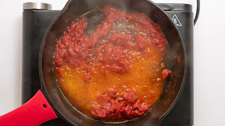 oil and tomato paste in pan