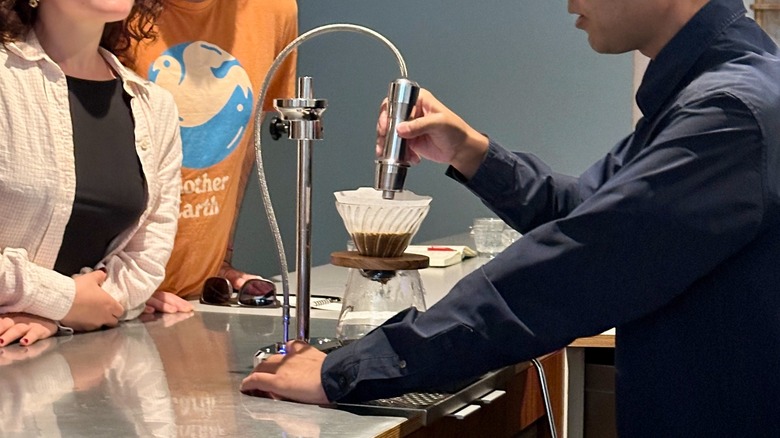 Barista making coffee at Endorffeine as customers watch
