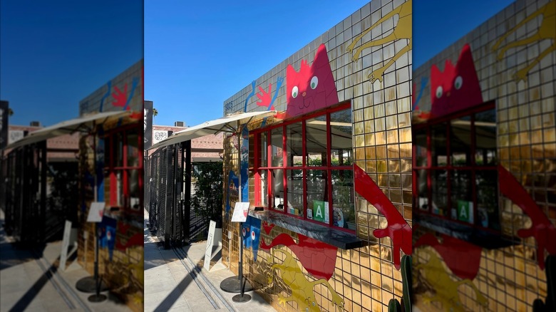 Gold-tiled building with an order window