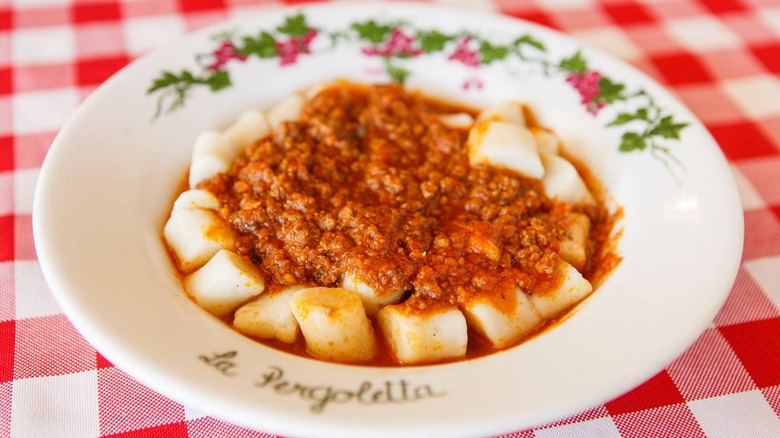 plates of pasta on red checked table cloth