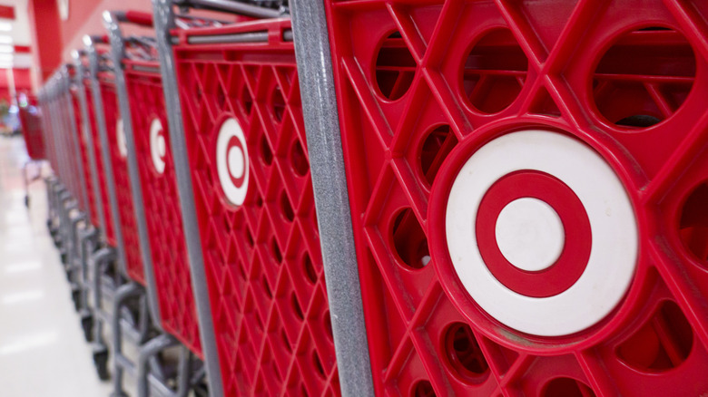 Row of Target shopping carts inside store.