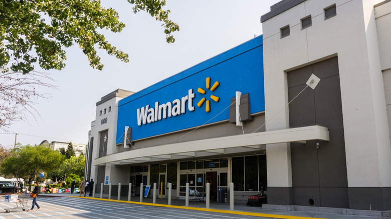 Blue, white, and gray exterior of Walmart store during daytime.