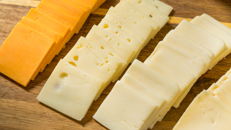 Square slices of Swiss, cheddar, and a white cheese in three rows