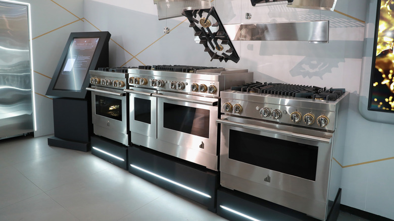 Modern stainless steel JennAir ranges and cooktops on display in a showroom