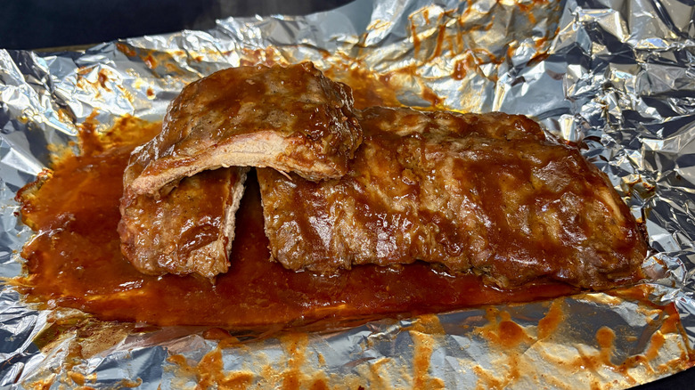 Cooked Curly's ribs on foil-lined pan