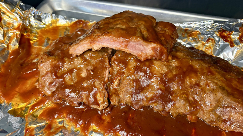 Cooked Smithfield ribs on foil-lined pan