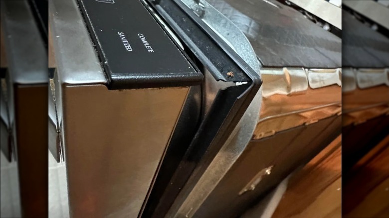 Close-up of dishwasher door that won't close all the way.
