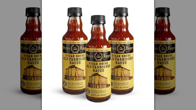 Three bottles of Peter Luger Steak House Old Fashioned Sauce against white background