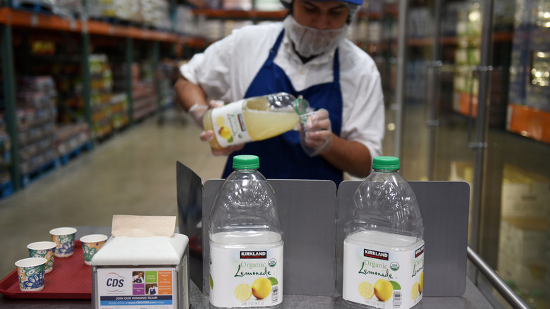 Worker pouring lemonade sample