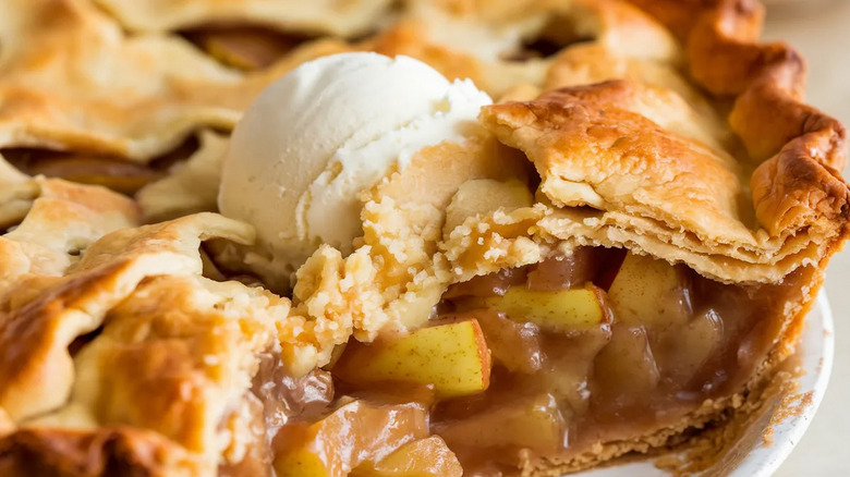 Close up of apple pie filling inside flakey crust