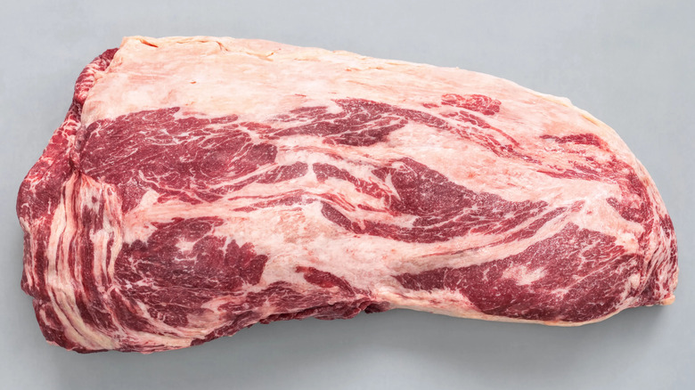 Closeup of uncooked beef brisket with fat and marbling