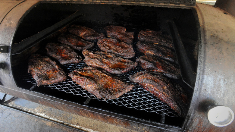 Multiple similar-sized briskets on large smoker