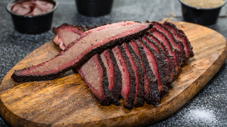 Sliced smoked brisket on cutting board