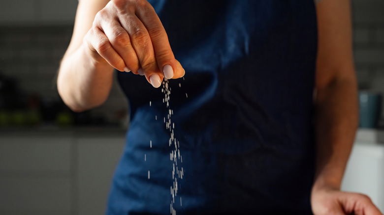 Person sprinkling salt