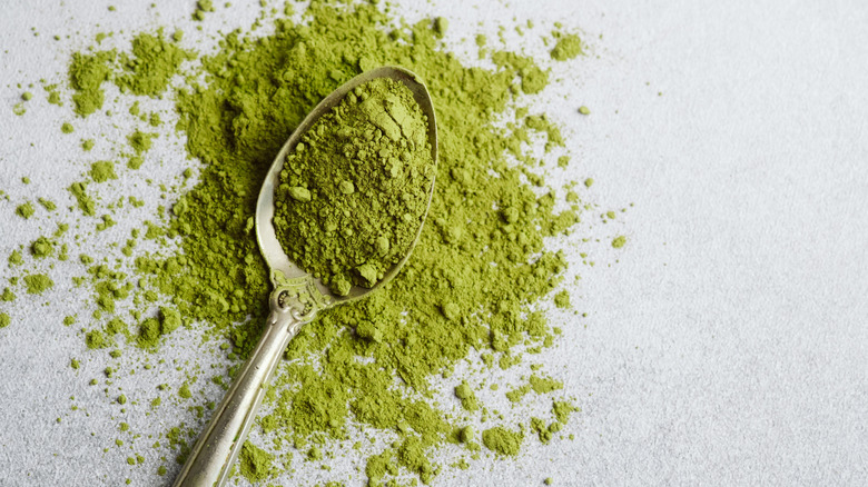 Matcha powder on and around spoon