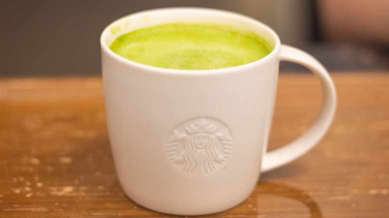 Hot matcha latte at Starbucks in a white mug