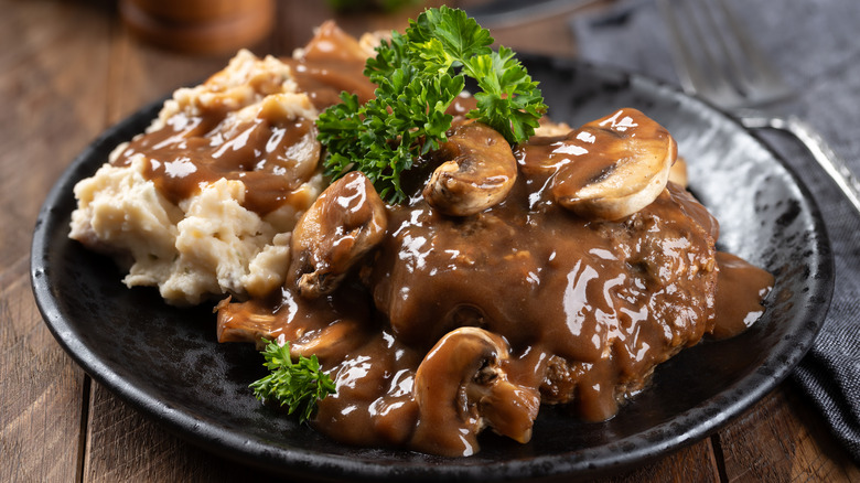 Salisbury steak with mushrooms, gravy, and mashed potatoes