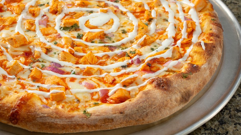 A buffalo chicken pizza with ranch swirled on top