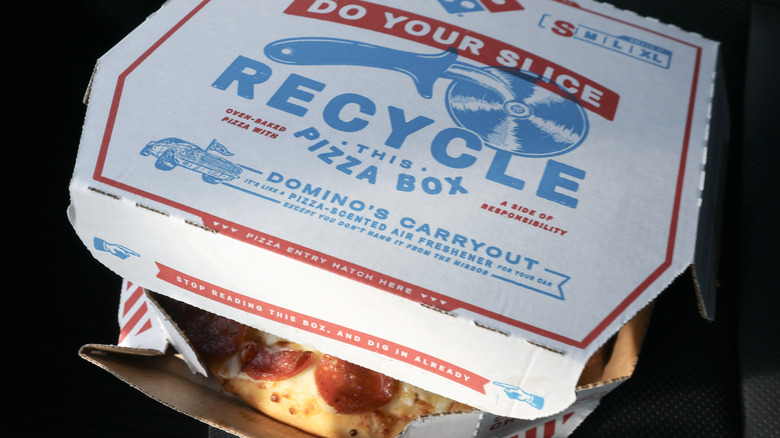 A half open Domino's pizza box