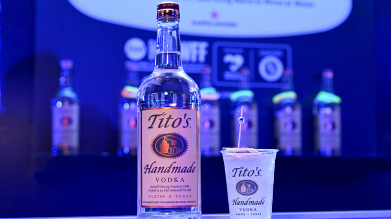 Bottle of Tito's vodka and drink in a branded glass