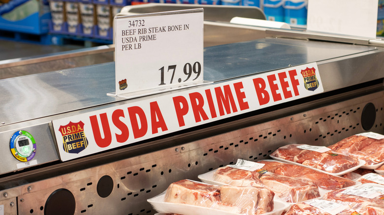 Signage reading "USDA Prime Beef" above Costco steak display.