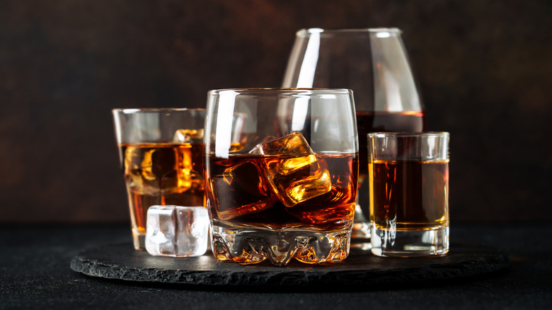 Dark liquor in various glasses