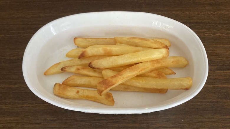 Crispy french fries in a white dish