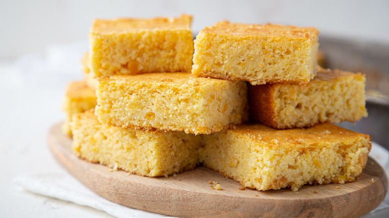 close up of cornbread on wooden board