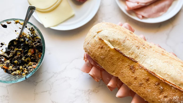 muffaletta sandwich with olive tapenade on side