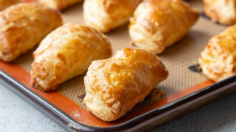 close up of southwest chicken empanadas on baking sheet