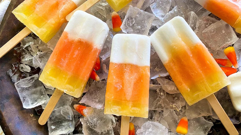 Layered orange, yellow, and white popsicles.
