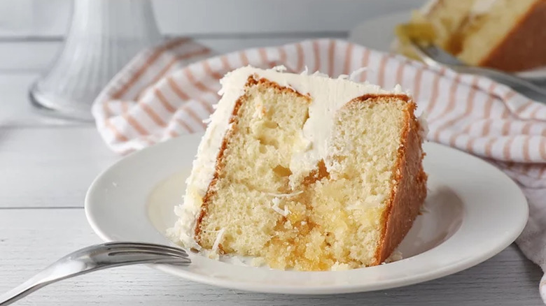 Slice of layer cake with white frosting and pineapple preserves.