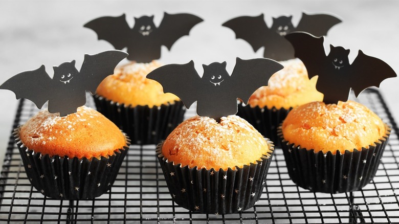 Orange muffins with bat toppers