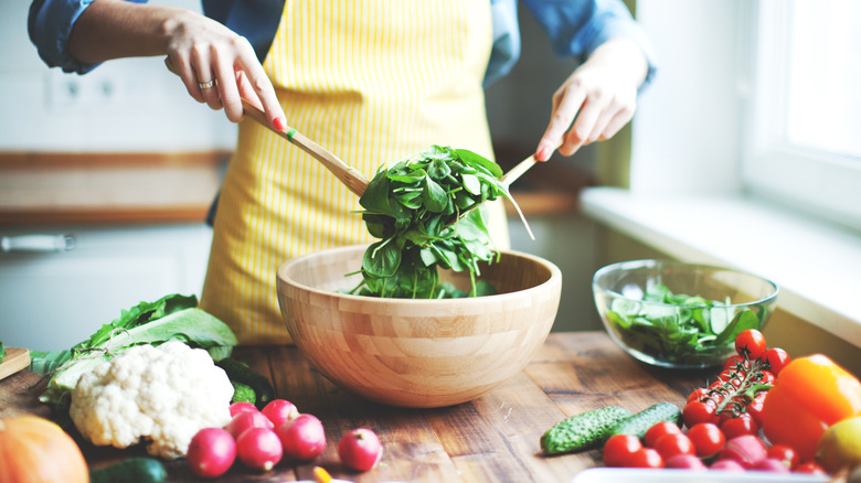 Home chef tossing a salad