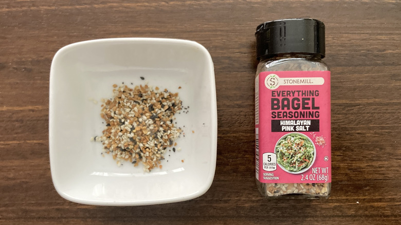 Pink Himalayan Salt Everything Bagel Seasoning in a small dish, next to the jar