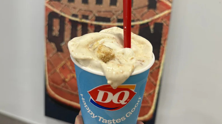 Dairy Queen Caramel Apple Cheesecake Blizzard Treat in front of a retro Dairy Queen logo
