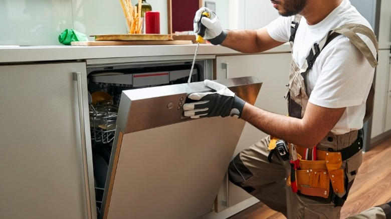 Technician fixing a dishwasher