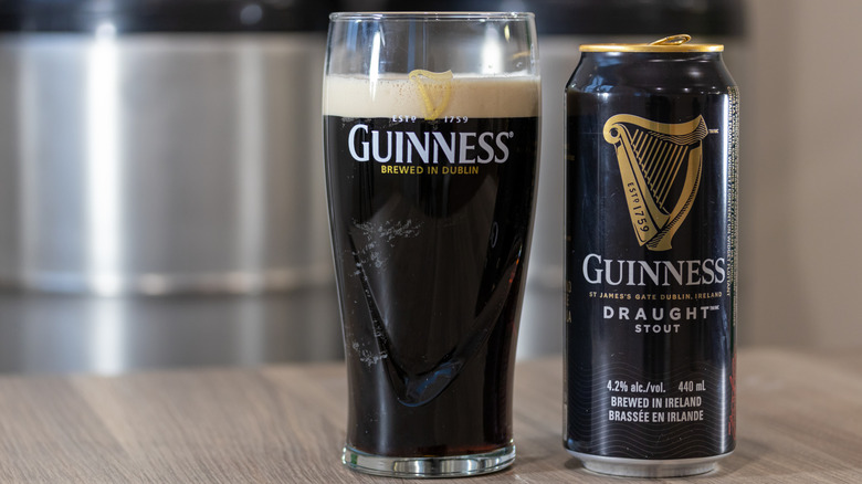 Can and pint glass of Guinness