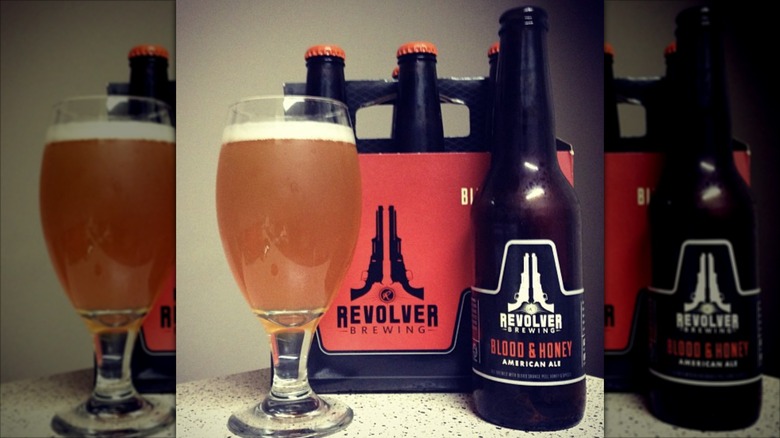 Bottles and glass of Revolver Brewing Blood & Honey American Ale