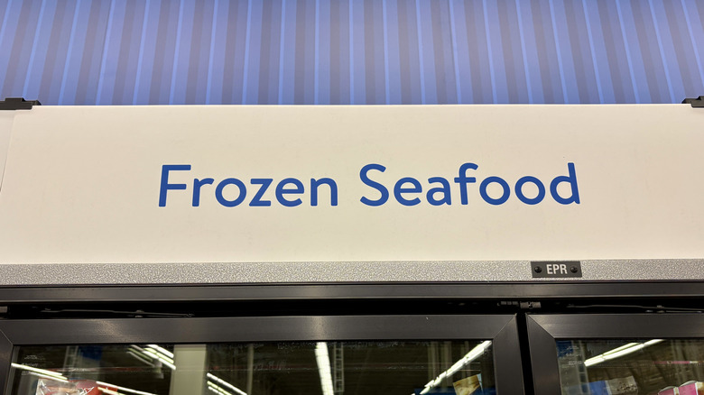 Frozen seafood sign above freezers