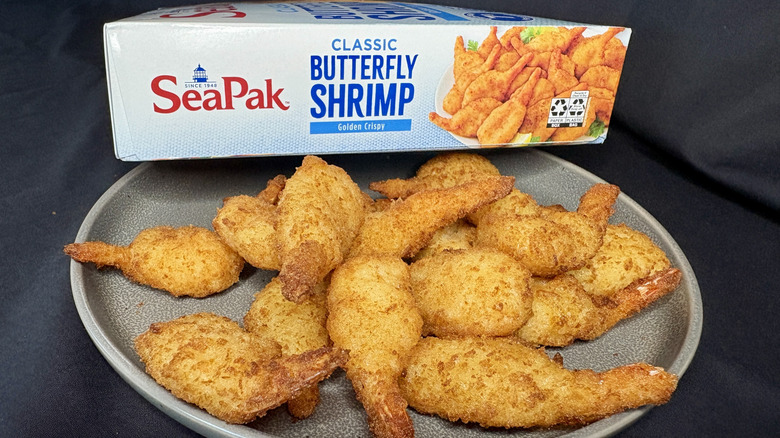 Breaded butterfly shrimp on plate in front of SeaPak box