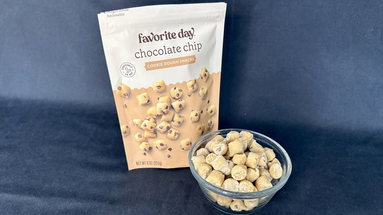 A glass bowl of Favorite Day Chocolate Chip Cookie Dough Snacks with the packaging behind