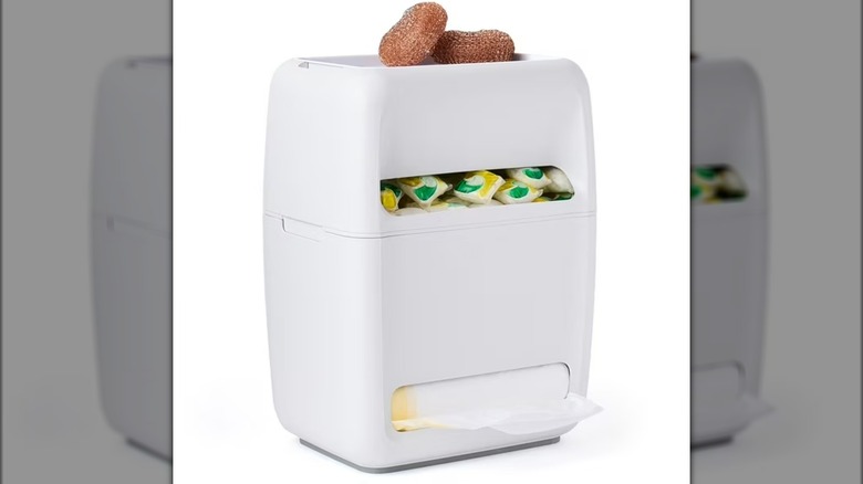 Under-sink receptacle for trash bags and dish detergent pods against white background.