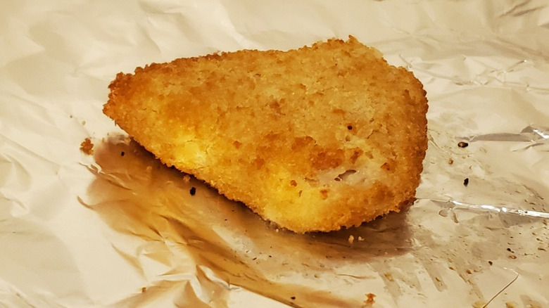 A breaded cod fillet on foil