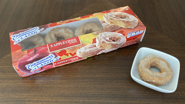 box of Entenmann's apple cider donuts in a package next to one on a mini plate