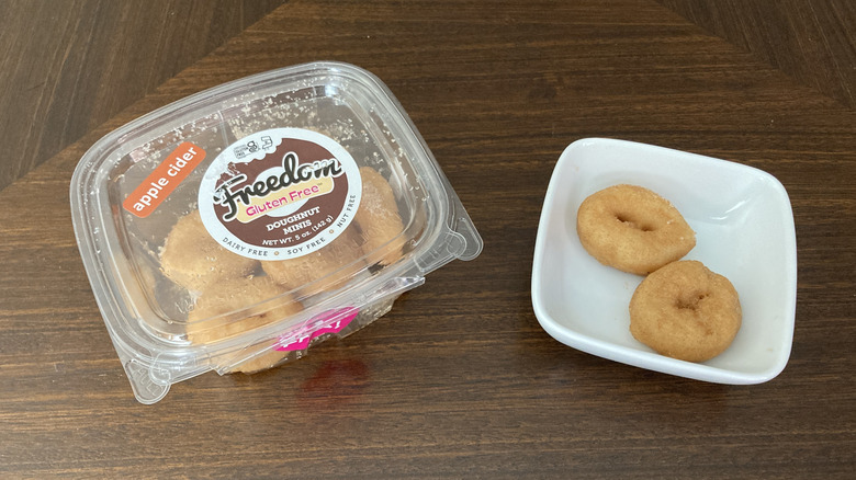 Freedom gluten free apple cider donuts in a package with two donuts on a mini plate